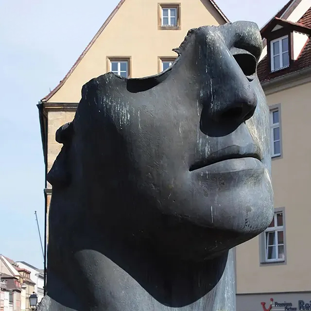 Close-up angled shot of Igor Mitoraj's Bronze Head Sculpture