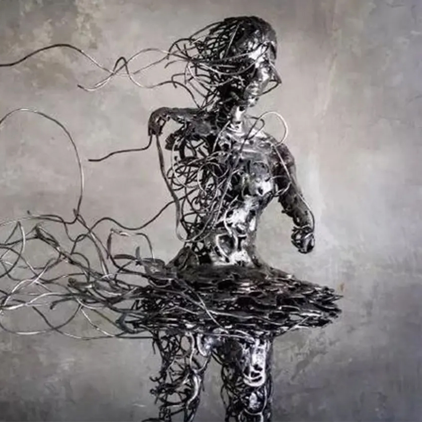 Close-up of Wire Ballerina Sculpture showing detailed torso and swirling wire hair elements