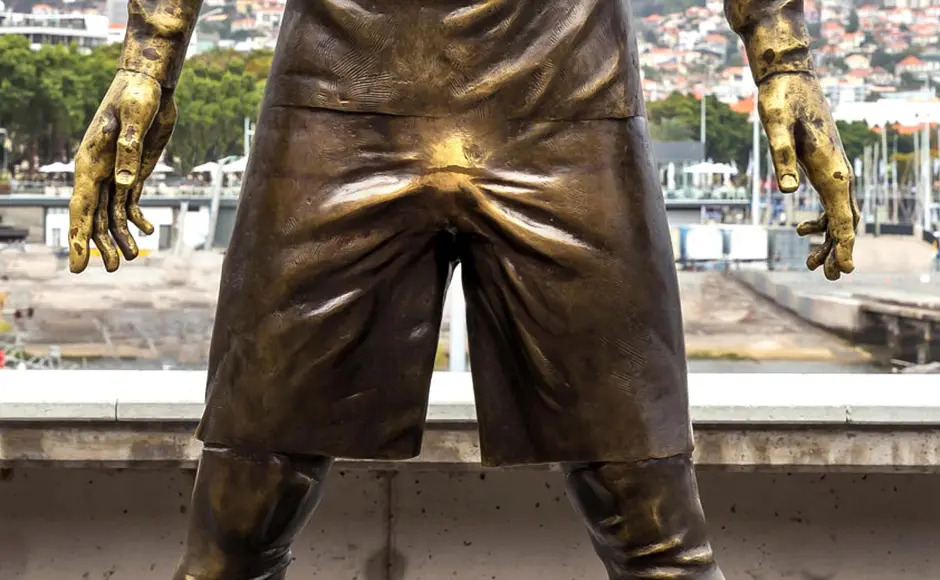 Close-up of bronze Cristiano Ronaldo statue with worn areas from frequent touching