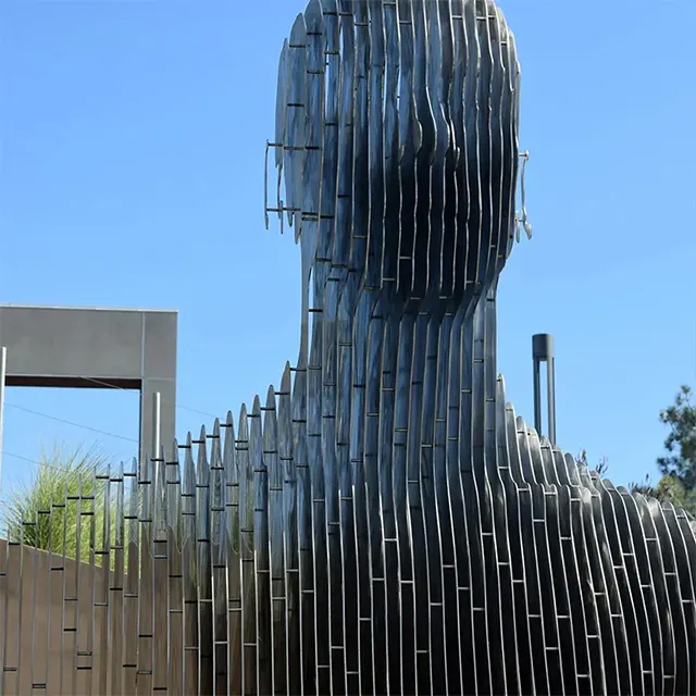 Close-up of stainless steel Disappearing Sculpture, showing vertical slices forming a human head silhouette