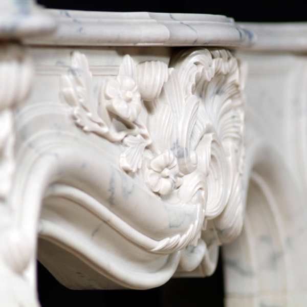 Close-up view of the central shell and floral carving on the Marble Mantel Surround