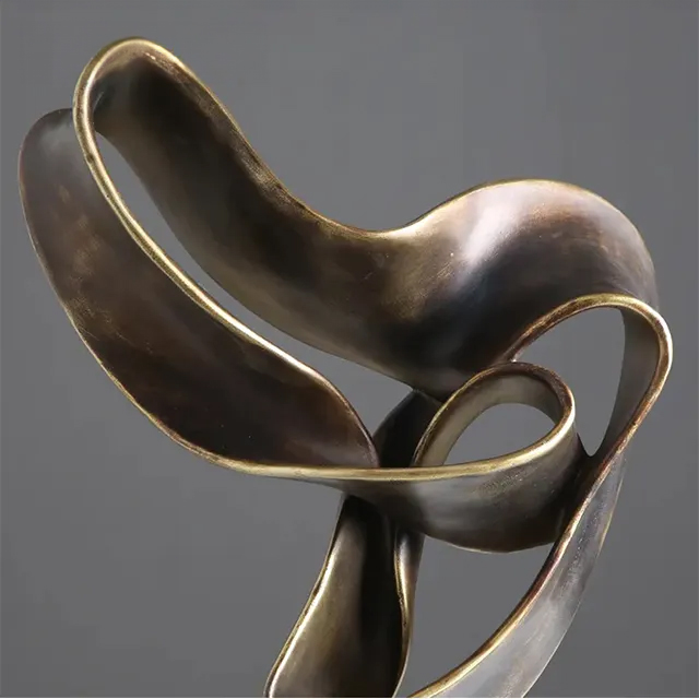 Detail view of Abstract Sculpture Decor in bronze showing smooth surface