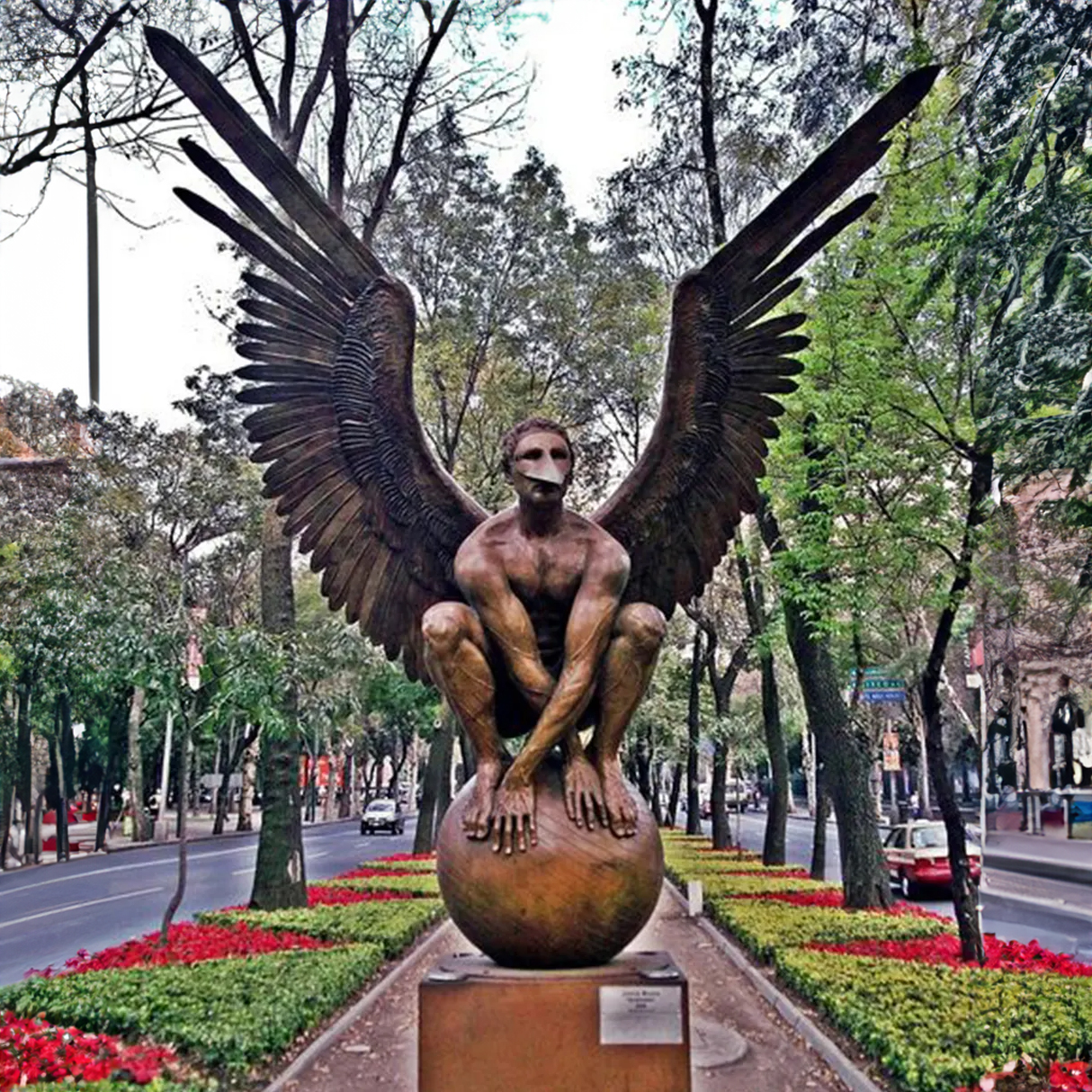 El Vigilante Sculpture in bronze featuring a winged crouching man on a sphere