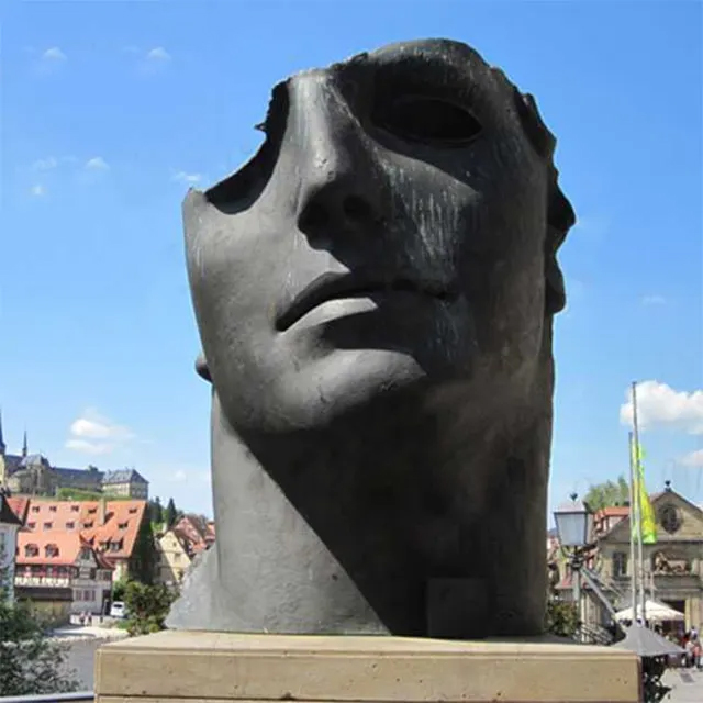 Front view of a Bronze Head Sculpture by Igor Mitoraj showing a fragmented face