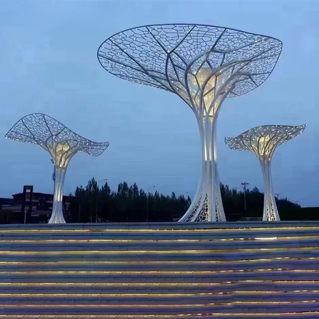 Illuminated Metal Tree Art Statue at night
