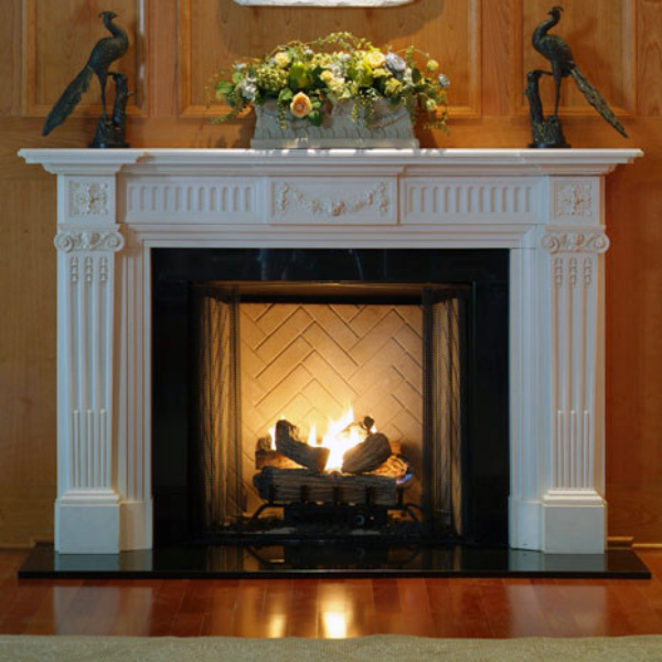 Installed Marble Fire Mantel with burning fire and floral decor