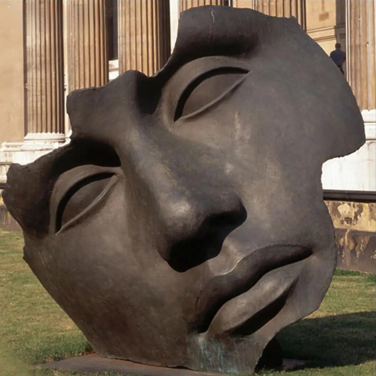 Large outdoor bronze sculpture titled Broken Face Statue by Igor Mitoraj