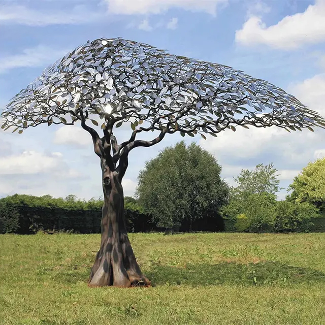 Large stainless steel tree garden sculpture with wind-swept leaf design