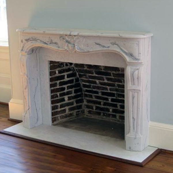Louis XV Fireplace Mantel installed in a traditional living room