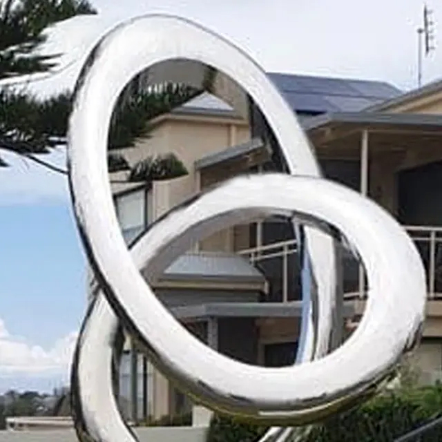 Outdoor installation of a polished stainless steel Loop Sculpture