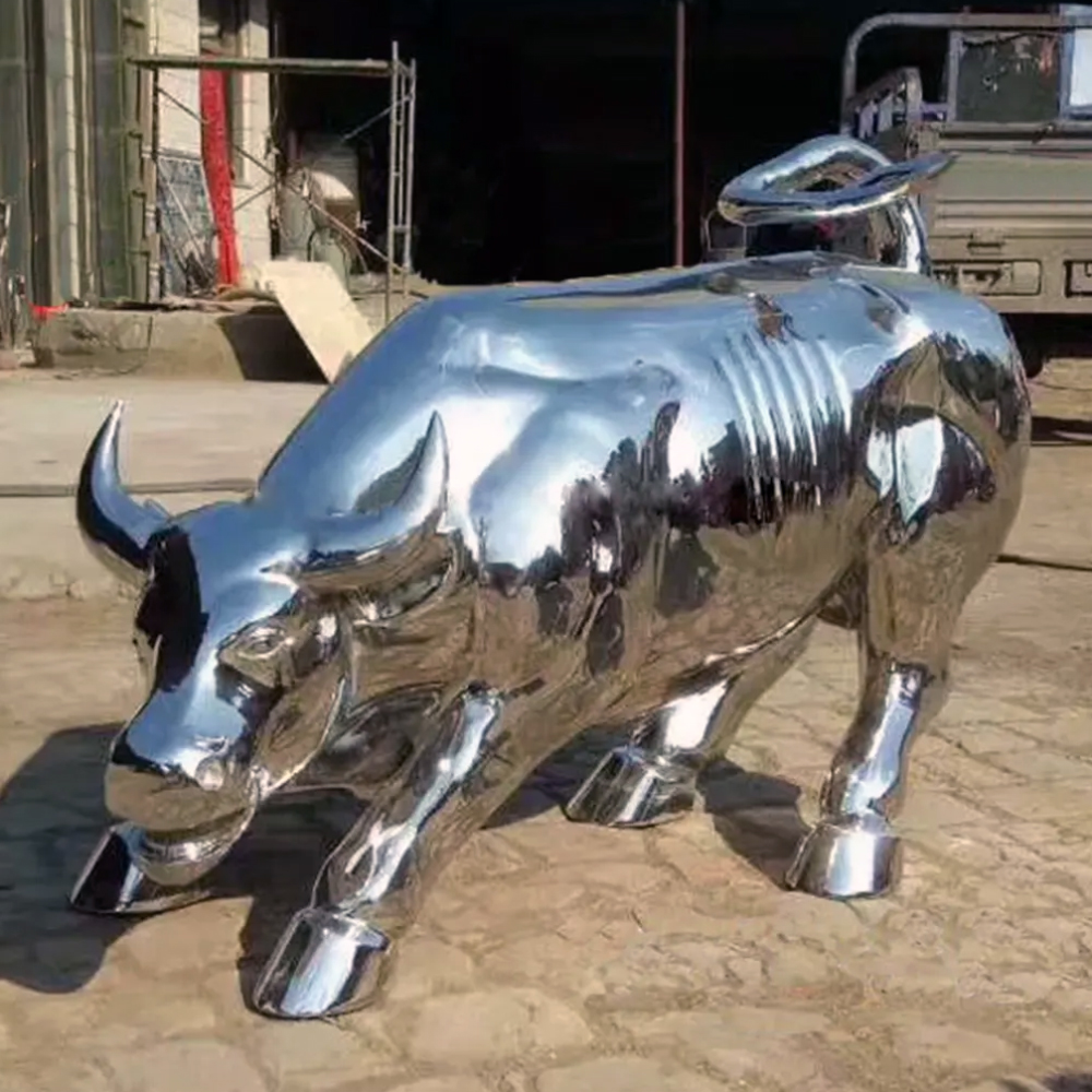 Shiny stainless steel bull statue displayed outdoors