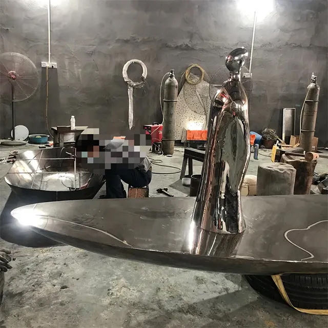 Stainless steel Abstract Boat Sculpture featuring a modern human form and a perforated sail design