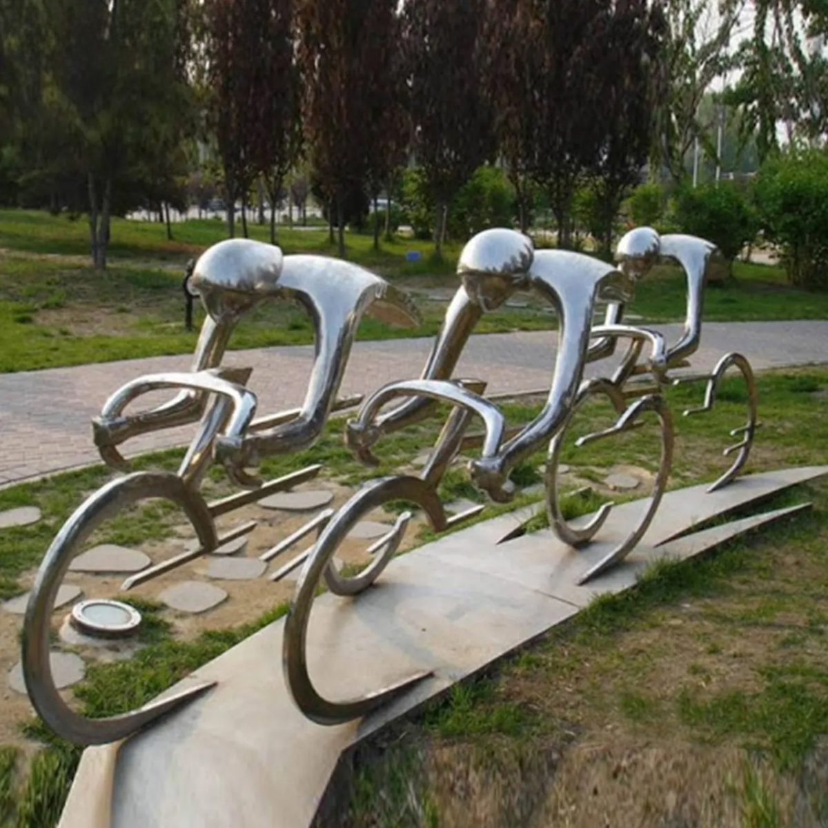 Stainless steel Cycle Statue depicting dynamic biker figures in motion