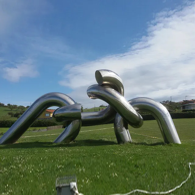 Stainless steel Metal Knot Sculpture by Pepe Noja displayed outdoors