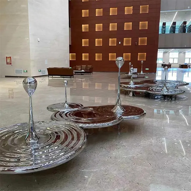 Stainless steel Raindrop Statue featuring mirrored ripple platforms and tall droplets