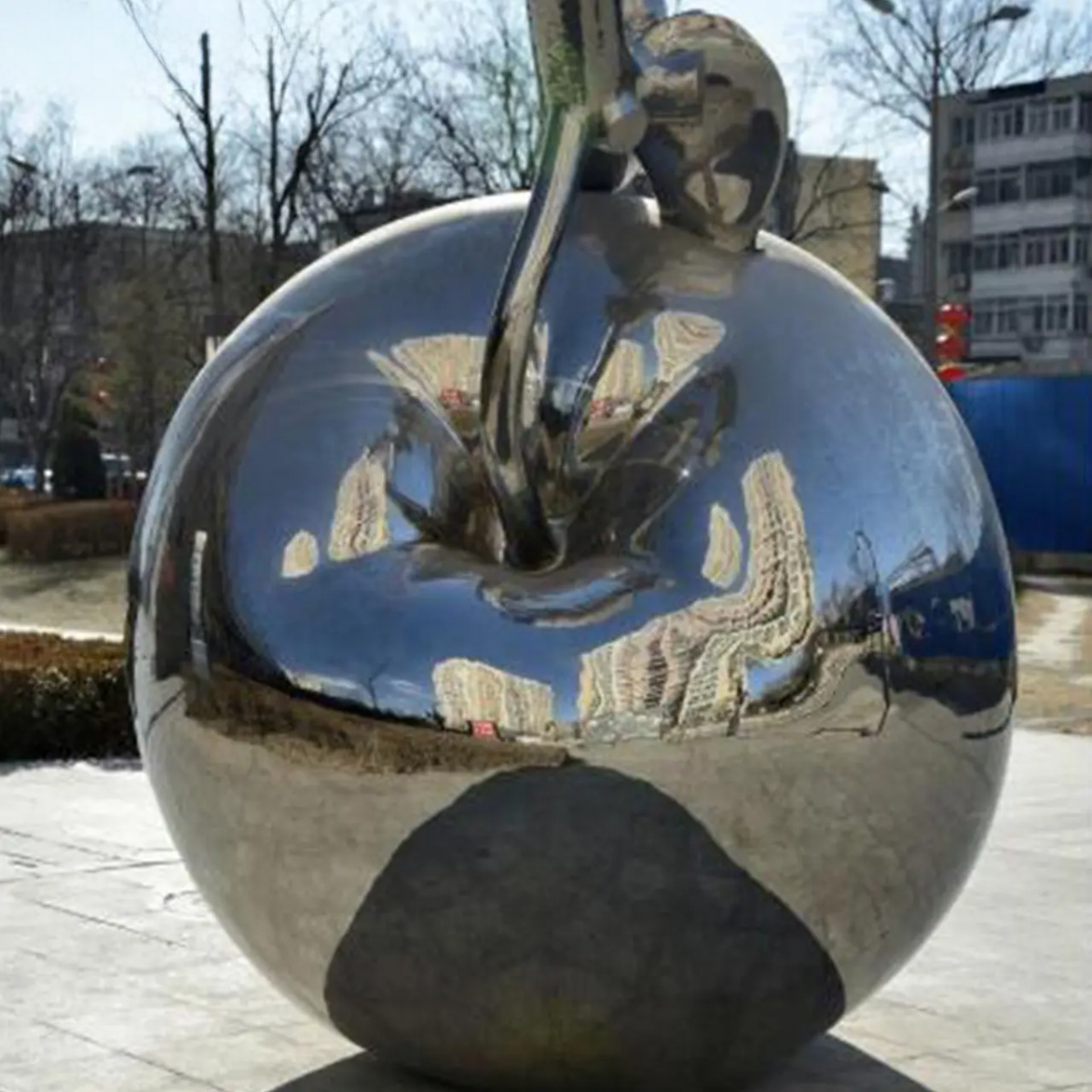 Stainless steel apple and child sculpture