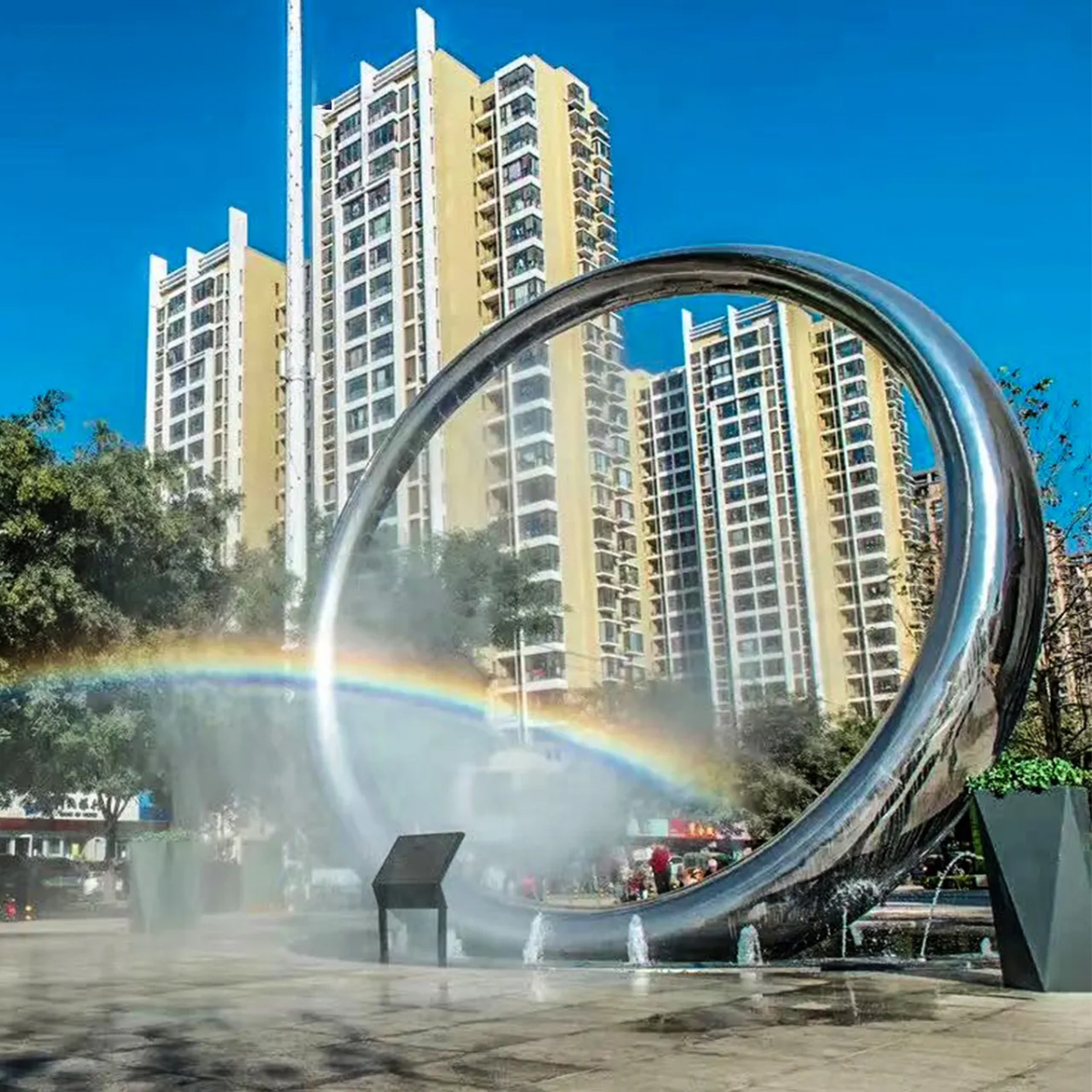 The Ring Sculpture in stainless steel stands in a city square