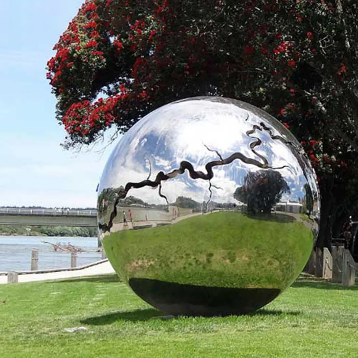 Unique stainless steel ball sculpture with abstract river-like pattern