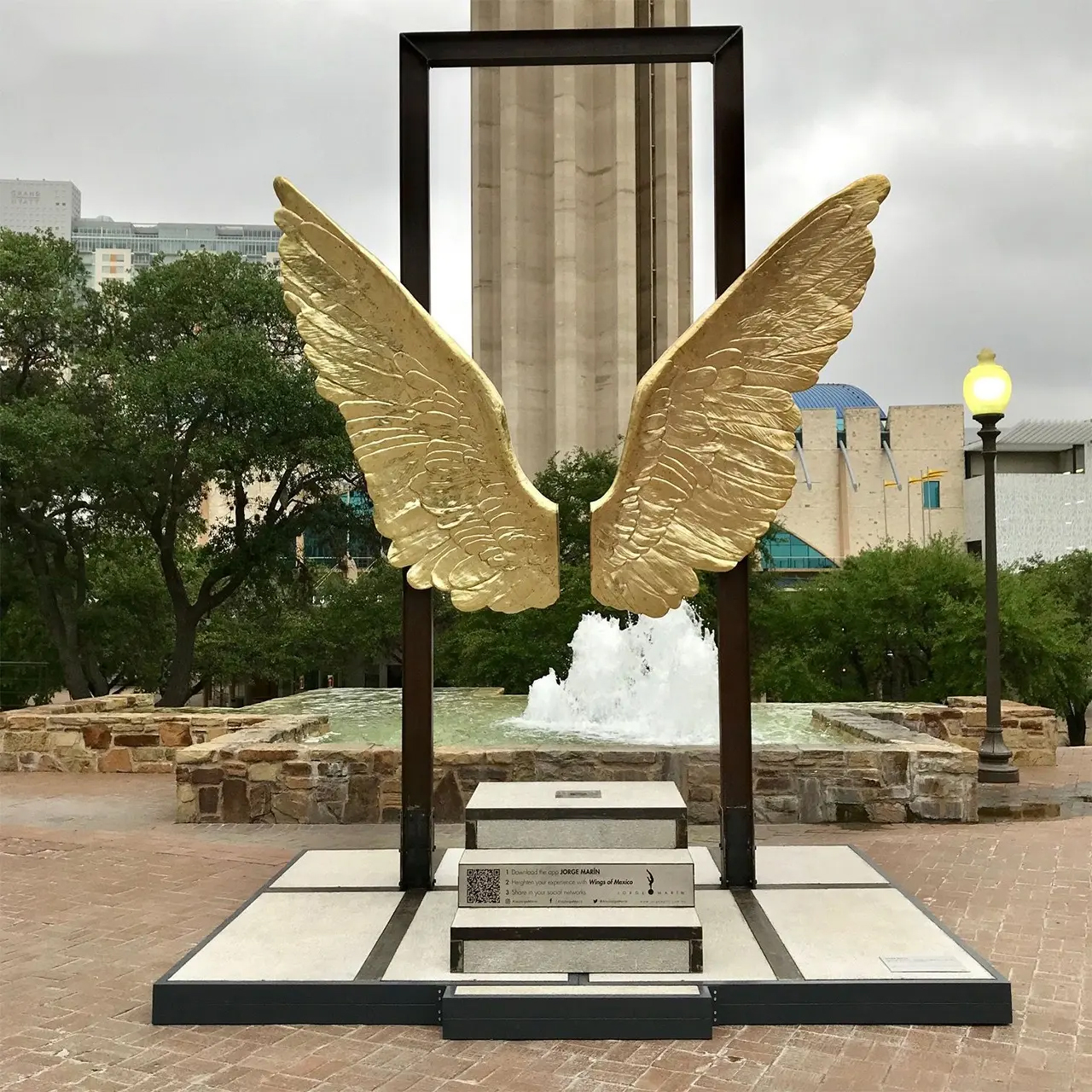 Wings of Mexico Sculpture with golden bronze wings in urban square