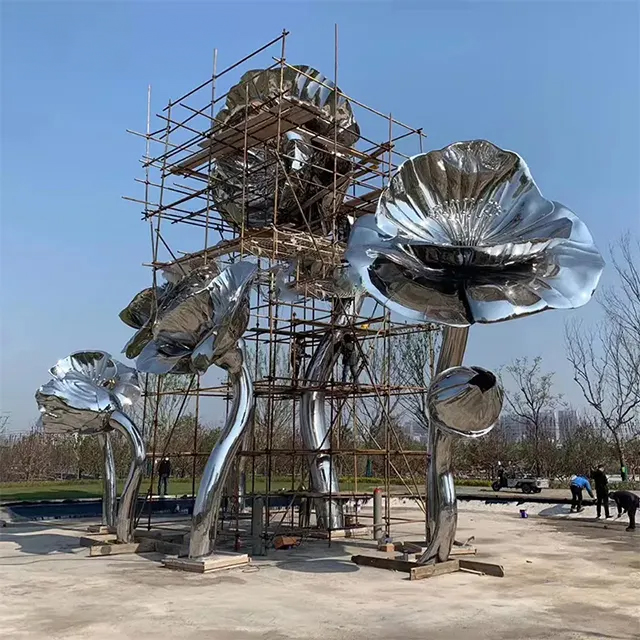 Workers assembling a Giant Flower Sculpture made of stainless steel