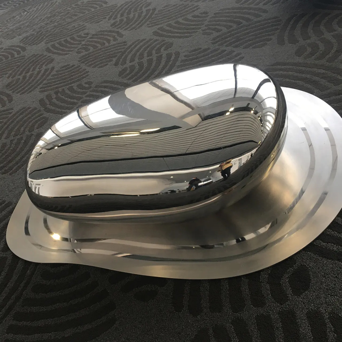 abstract stone-shaped polished steel sculpture