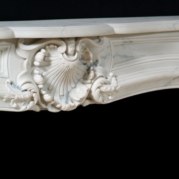 floral carving detail of the Modern Marble Mantel showcasing leaf and scroll accents
