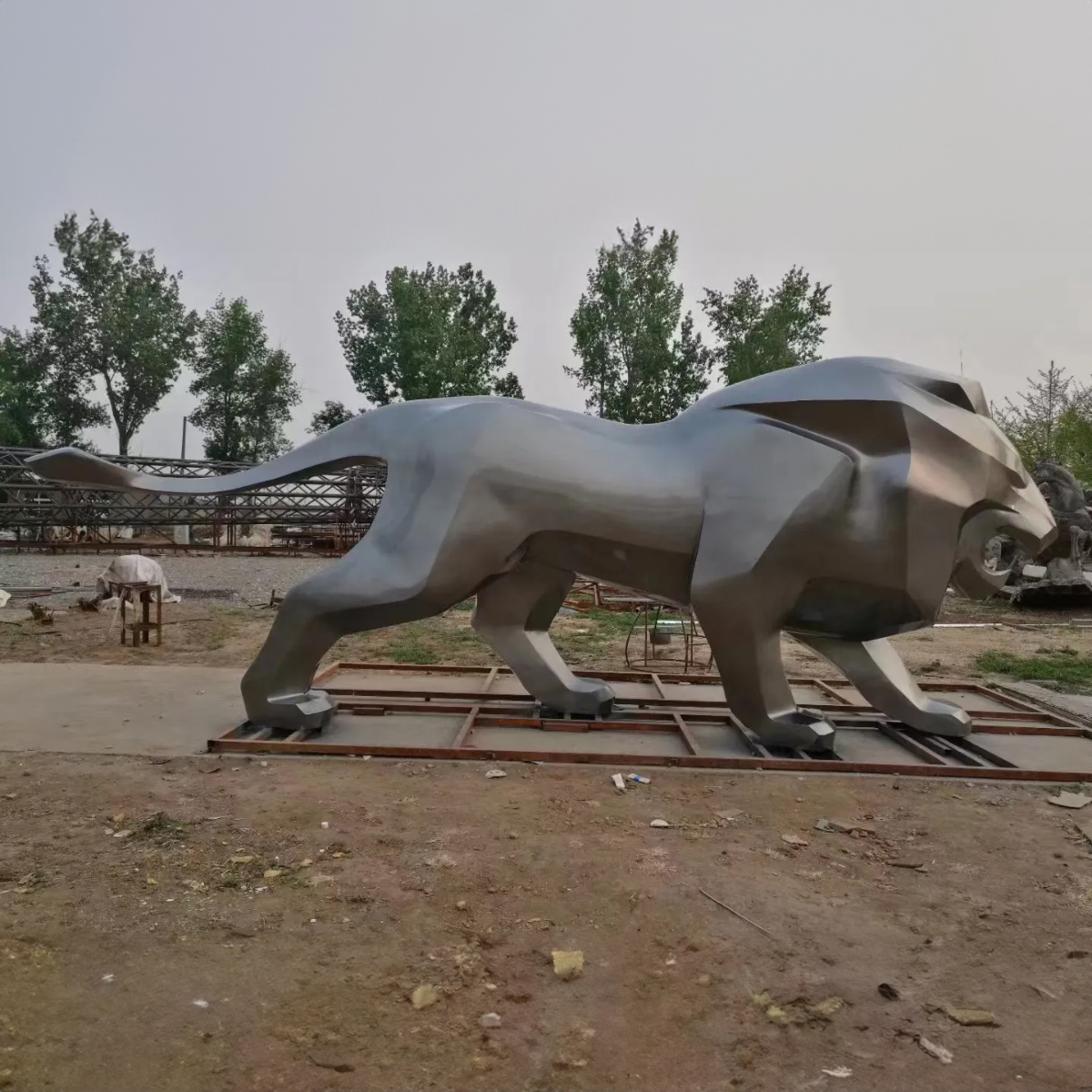 large stainless steel Metal Lion Sculpture in a walking stance