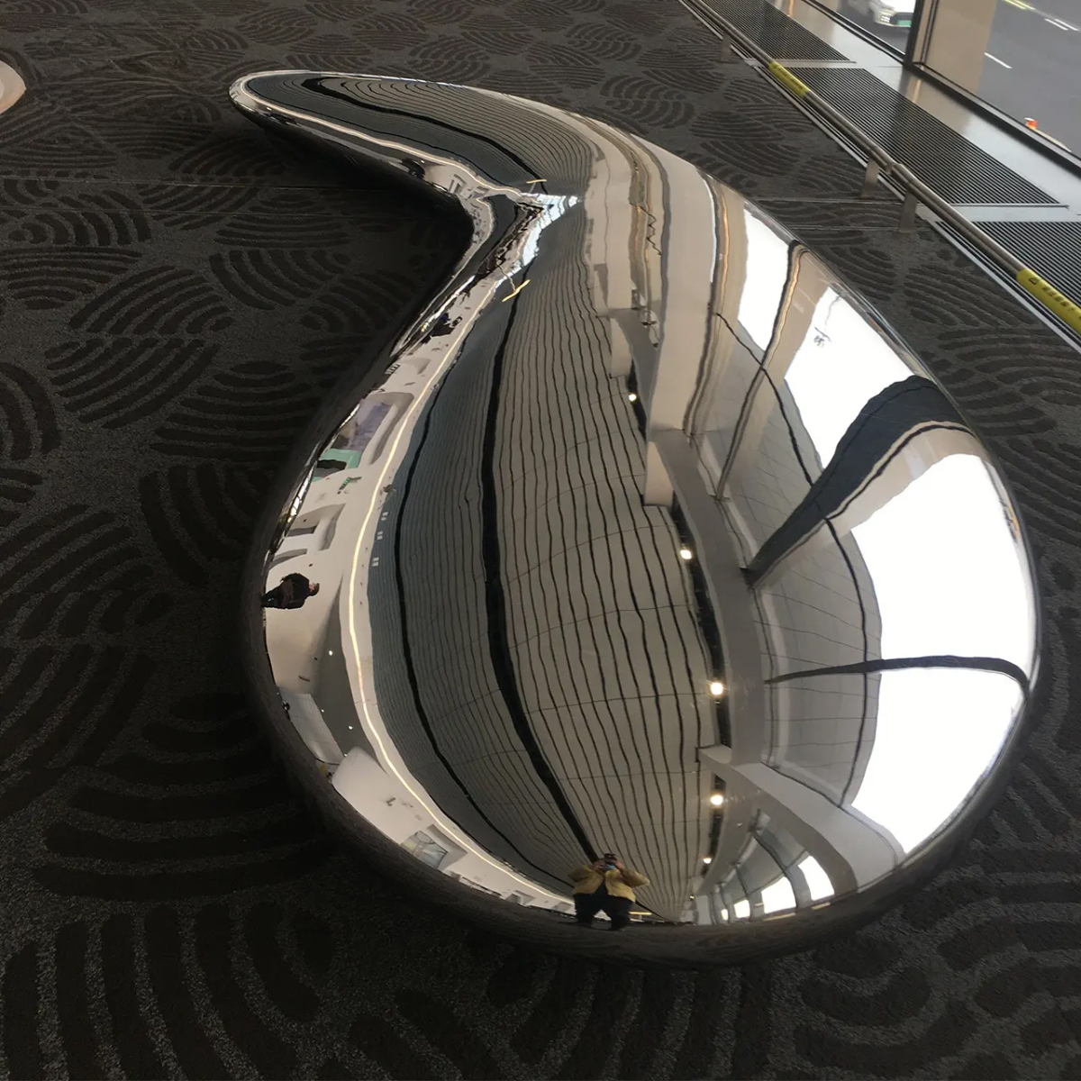 modern teardrop-shaped polished steel sculpture