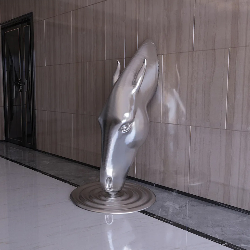 stainless steel horse head sculpture appearing to drink water