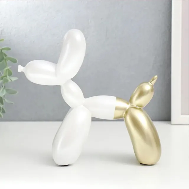 A white and gold Balloon Puppy Sculpture crafted from stainless steel