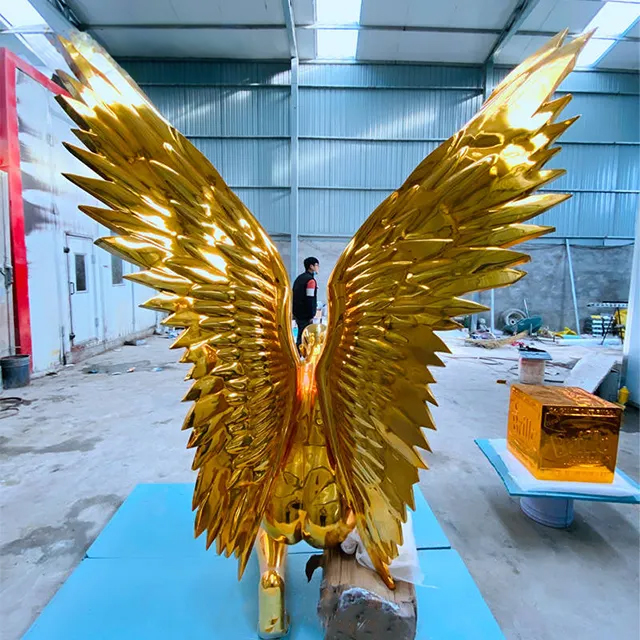 Back view of stainless steel gold angel sculpture