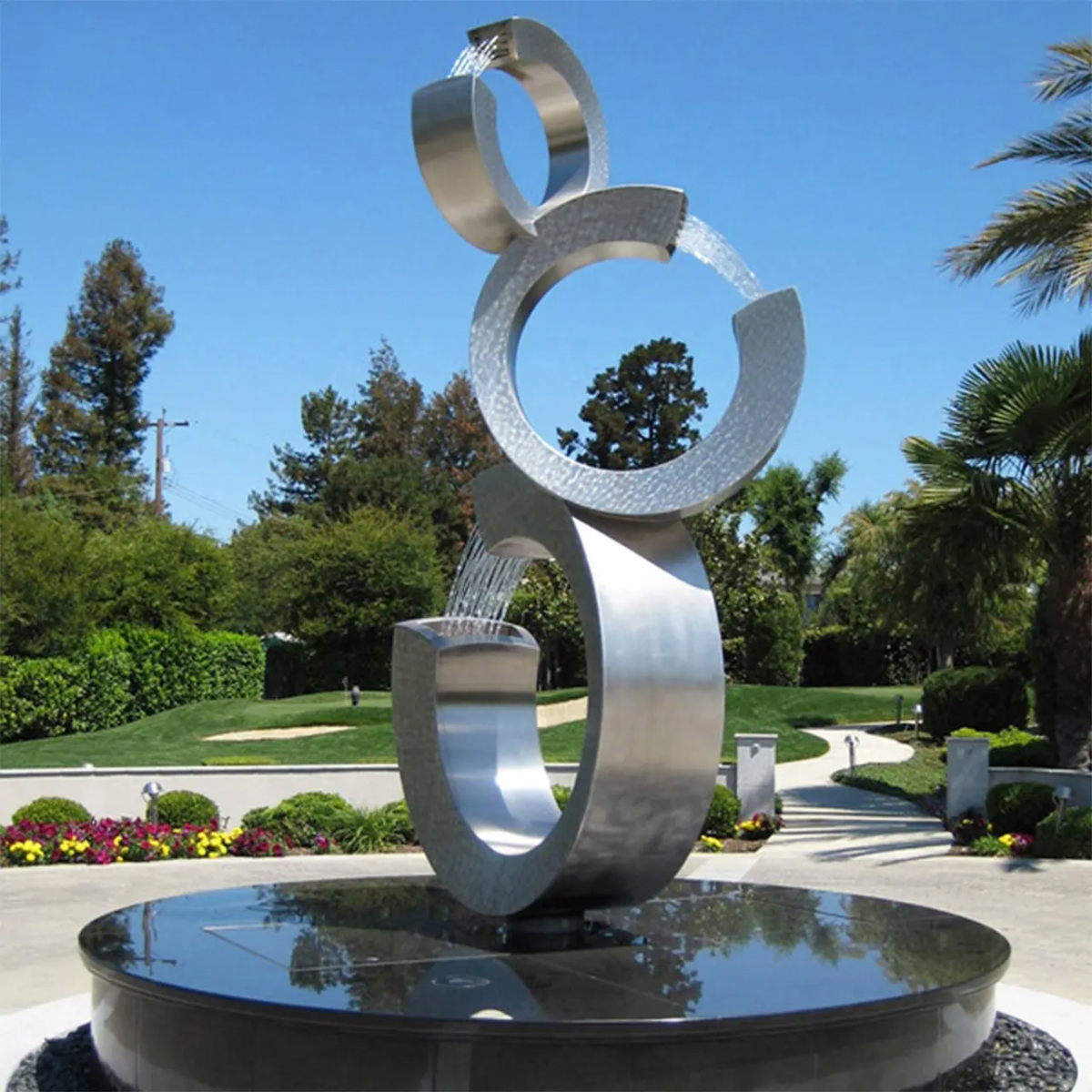Circular Garden Water Feature in stainless steel with three stacked open rings