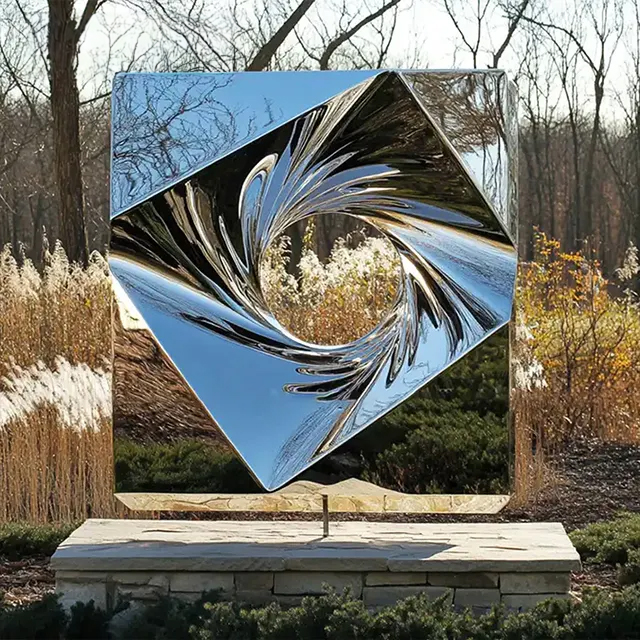 Contemporary stainless steel abstract cube sculpture with swirling circular hollow center