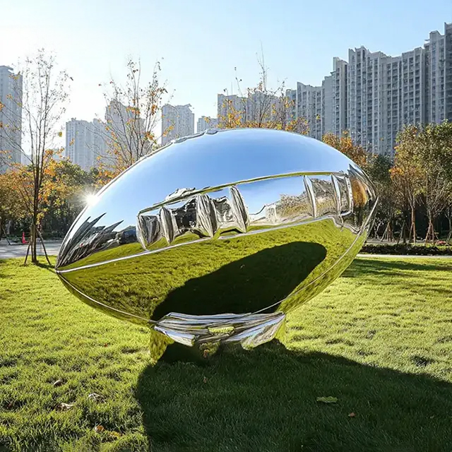 Contemporary stainless steel american football statue