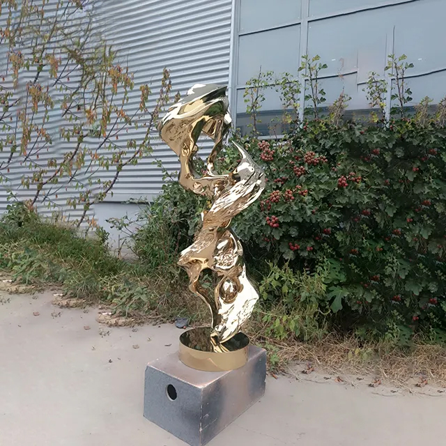 Contemporary stainless steel rock sculpture with gold electroplated surface