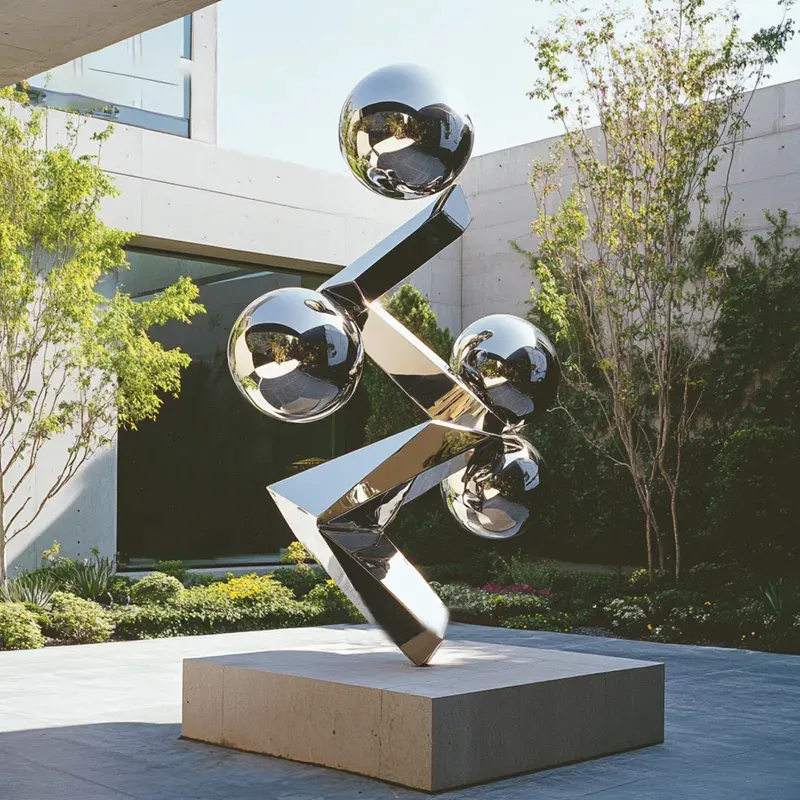Contemporary stainless steel sculpture featuring polished metal spheres and sharp-edged beams
