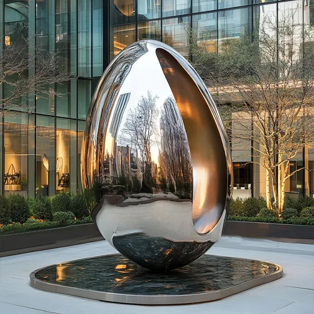 Egg shaped sculpture in stainless steel with polished mirror surface and hollow opening