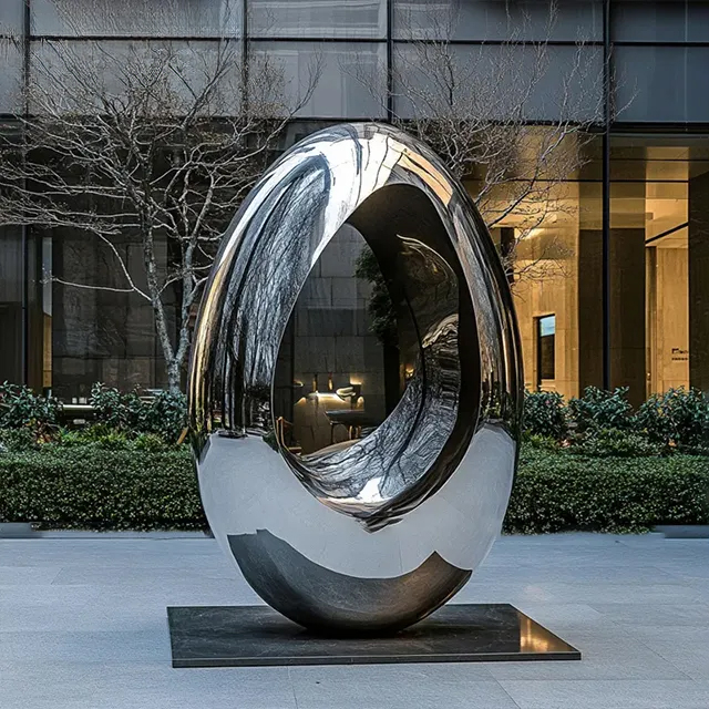 Egg shaped sculpture in stainless steel with reflective polished surface