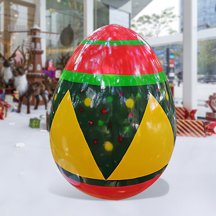 Giant Egg Statue made of fiberglass with red, green, and yellow festive pattern