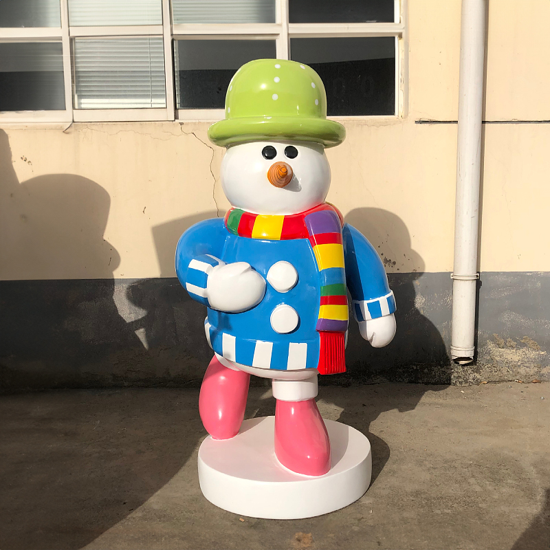 Giant Outdoor Snowman Sculpture made of fiberglass, features a snowman in blue outfit, colorful scarf, green hat