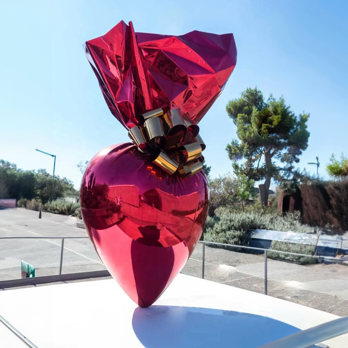 Jeff Koons Candy Sculpture in red heart shape with gold ribbon, made of stainless steel