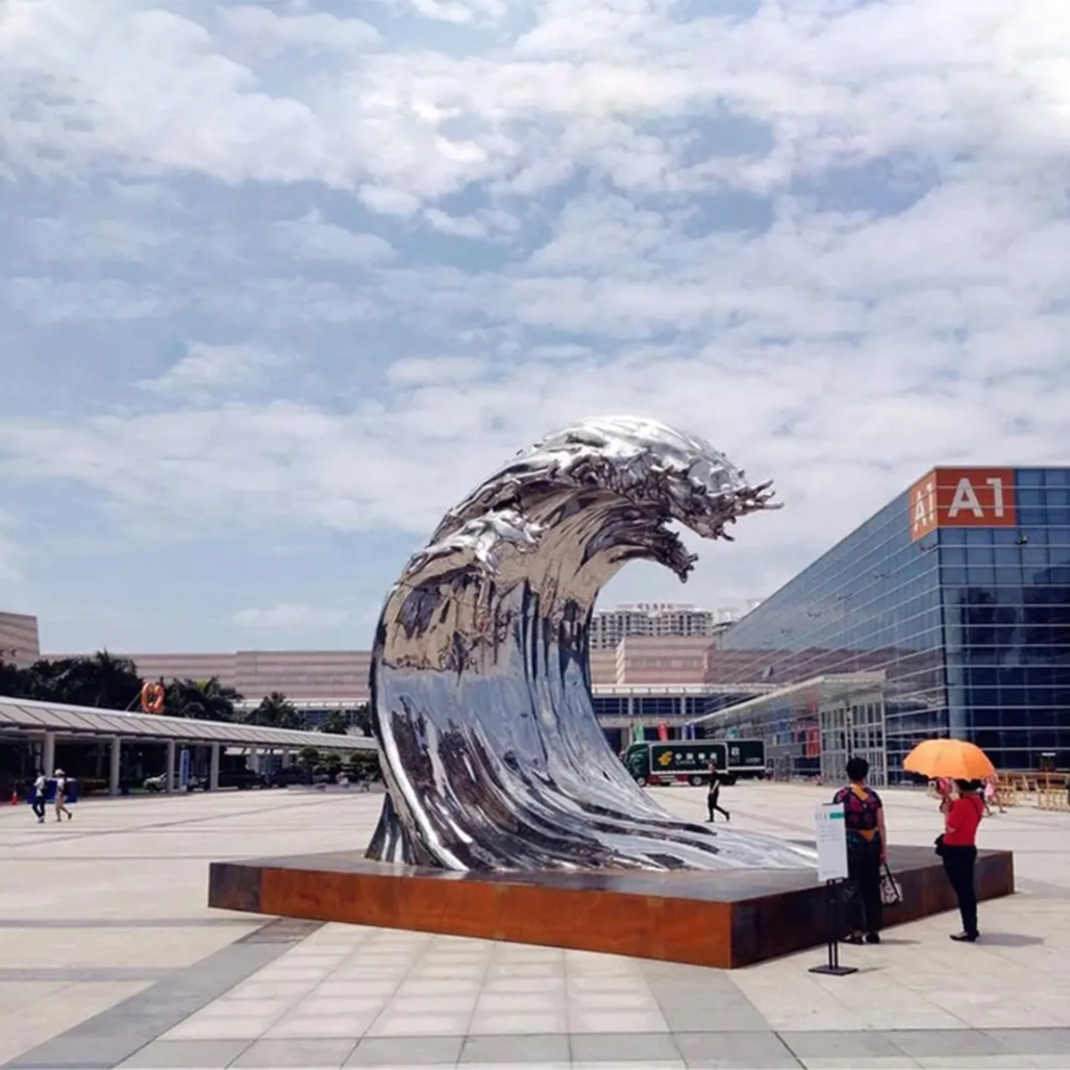 Large Abstract Water Inspired Statue in stainless steel forming an upward rolling wave