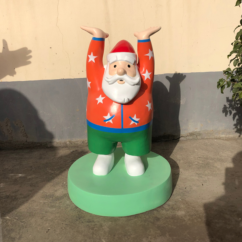 Large Outdoor Santa Statue, fiberglass material, depicts a Santa in orange star - printed top and green pants