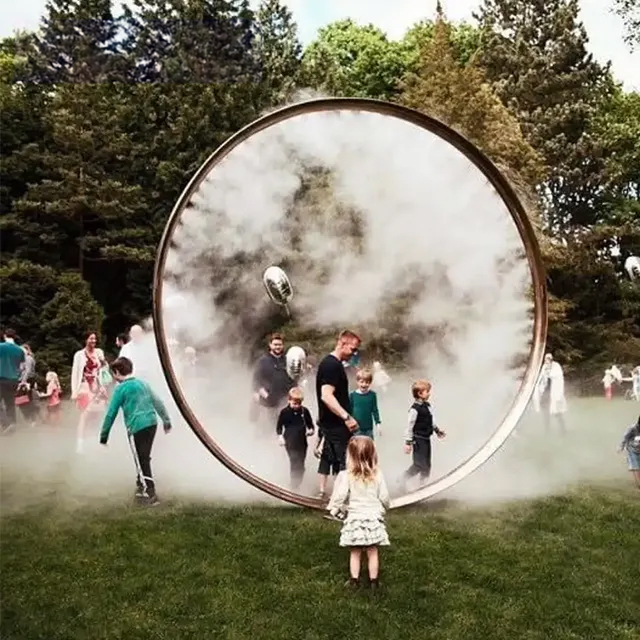 Large Round Water Feature made of stainless steel, surrounded by mist