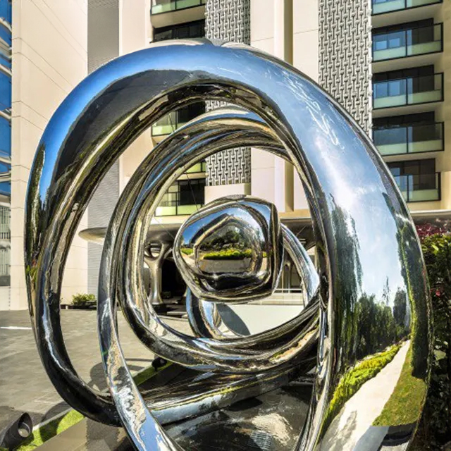 Large-scale stainless steel abstract sculpture with flowing geometric lines