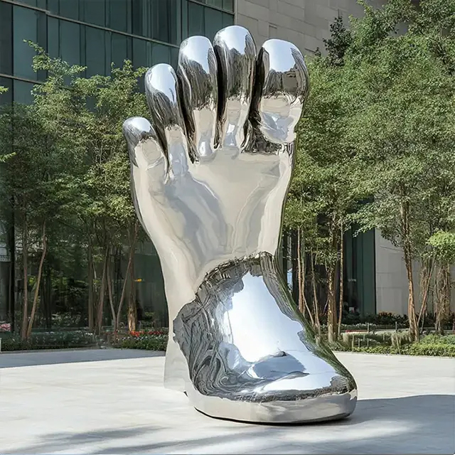 Large stainless steel Shoe Art Sculpture combining a giant foot with footwear elements