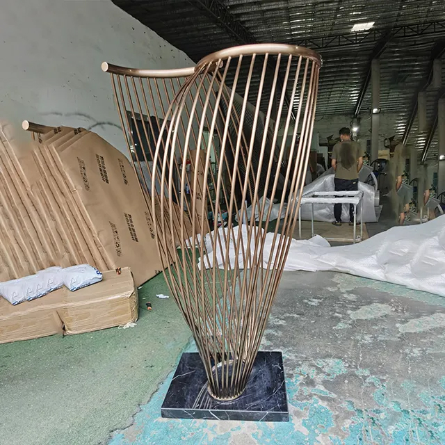 Metal Rod Sculpture made of stainless steel, featuring curved bronze-finish rods twisted upward from a marble base