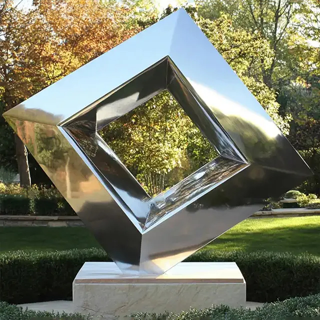 Mirror polished stainless steel abstract cube sculpture with central hollow diamond shape