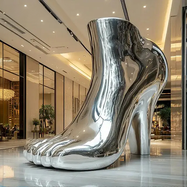 Outdoor stainless steel High Heel Shoe Sculpture blending a human foot and high heel design