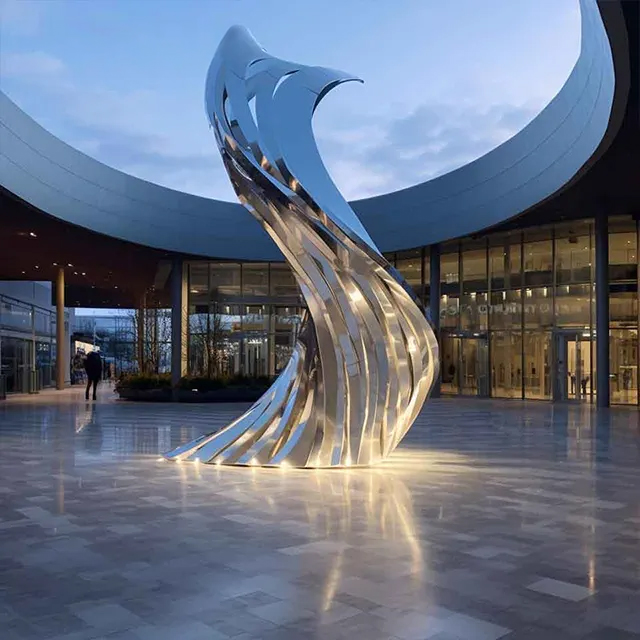 Outdoor stainless steel sculpture shaped like a dynamic metal ribbon
